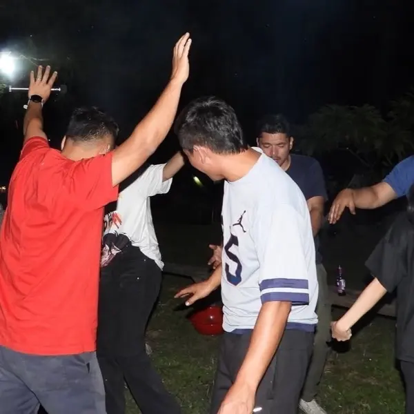 Dancing around a campfire at an evening offsite