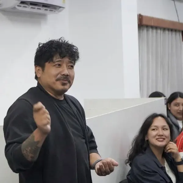 A colleague speaking to the room during an office session