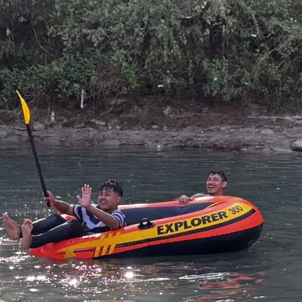 Two of the team out on the river in an inflatable raft
